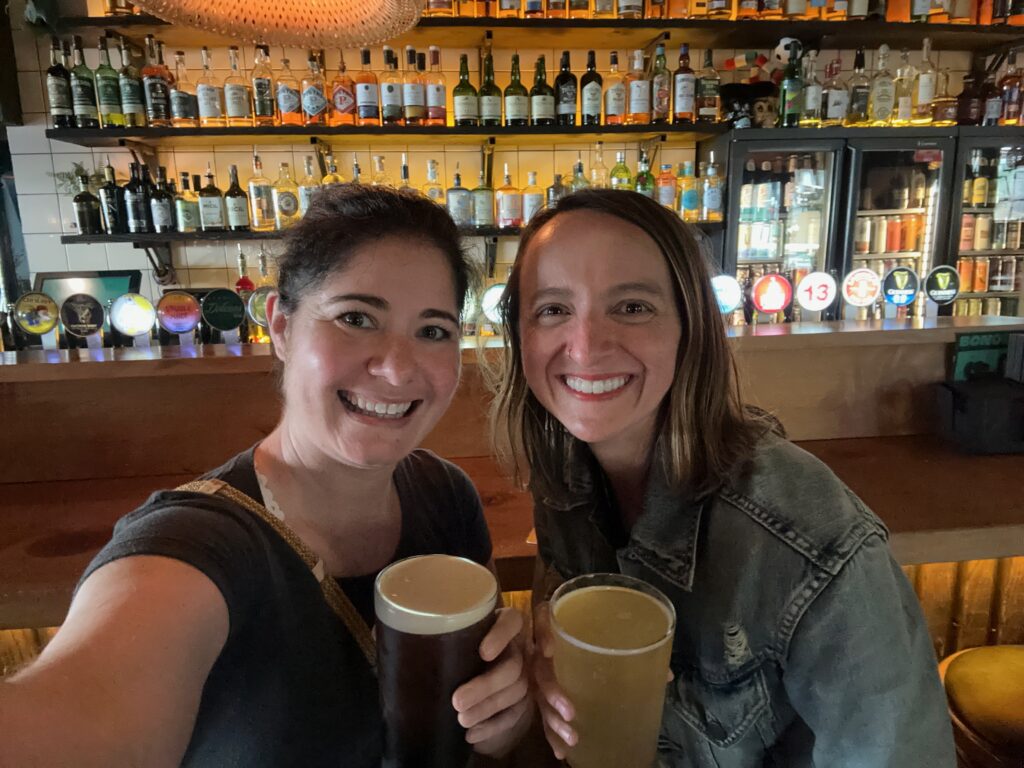 Kimberly and Nicole cheersing with beers