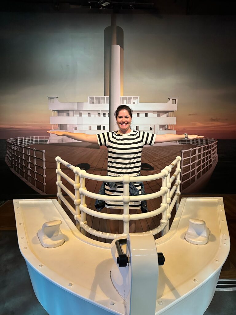 Kimberly posing at front of ship replica 