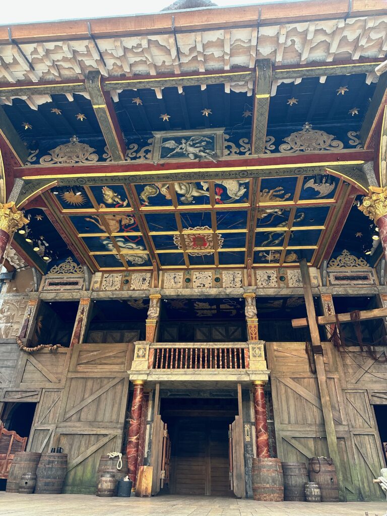 Close up of the stage ceiling at Globe Theatre. It is decorated in beautiful dark blue and gold artwork. 